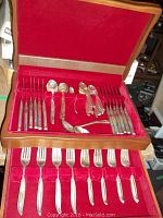Full view of two-level flatware case showing forks in lower drawer and knives, spoons and serving pieces in upper drawer.