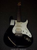 Front view of the black Renegade electric guitar, showing the body, pickguard, and neck