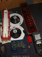 Lot contents showing Tonka fire truck, ceiling speakers, box of computer SDRam chips, transformers, and switch box.