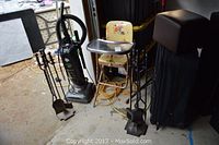 Vintage metal baby high chair with cartoon character padded seat and metal tray, Dirt Devil upright vacuum, two sets of metal fireplace tools (black and brown) and Skyline suitcase.