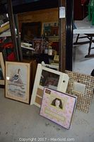 Overall view of the lot showing framed wild fowl print, multiple framed mirrors, photo frames and other framed decor items arranged on the floor.