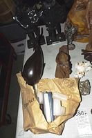 Photo capturing several carved wooden animal figurines, metal knight sculptures, and other small decorative wood items on display.