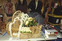 Photo showing collection of faux floral arrangements with cream and peach flowers, some white roses, and rustic burlap wrapping.