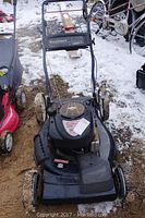 Full front and side view of the black Craftsman lawn mower in outdoor setting with some snow on the ground, showing overall condition and structure.
