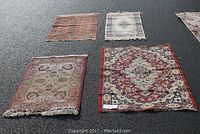 Overview photo of all four small area rugs laid out on a dark surface, showing colors and patterns to identify each rug.