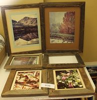 Six barnwood frames on a flat surface. Four frames display various nature photographs including mountains, autumn trees with geese, and flowers. One frame is empty.