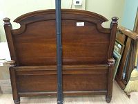 Dark wood bed frame headboard and footboard front view showing style and finish.