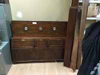 Full view of the Ethan Allen Canova storage headboard showing three round lights on the top light bar and three drawers below them with detailed wood paneling.