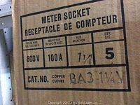 Photo showing the specifications printed on the cardboard box containing the meter sockets including voltage max of 600V, main capacity 100A, copper material, model BA3-1 1/4, quantity 5.
