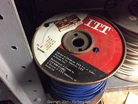 Spool of blue insulated wire labeled ITT brand.