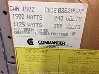 Close-up of Commander heater label showing model number CWA 1502, power specifications, and manufacturer information.
