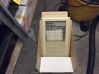 Four boxed Federal Pioneer forced air floor drop-in heaters FDH15 Series B stacked on a shelf and one heater unit partially unpacked in a box.