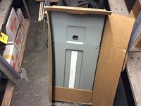Gray Federal Pioneer breaker panel inside open cardboard box.