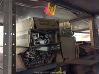 Shelving with multiple boxes containing fluorescent tubes, showing tube ends and partially opened boxes.