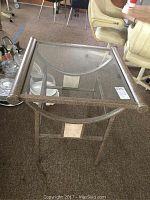Top view of glass top end table showing transparent surface and metal frame.