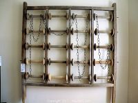 Full front view of the wooden spool rack against a wall