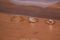 Three rings on wooden surface, front view