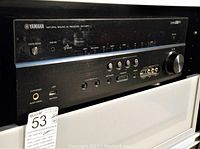 Yamaha RX-V671 front panel showing power button, input selector knob, headphone jack and USB port
