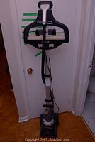 Full view of freestanding Rowenta garment steamer showing base, pole, hose, head and integrated hanger