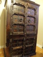 Full front view of dark-stained carved rosewood cabinet