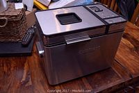 Front view of the Cuisinart bread maker showing stainless steel exterior and digital control panel with lid window.