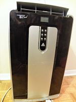 Front view of portable air conditioner and heater unit showing digital control panel and air vent