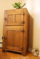 Full front view of oak ice box showing two doors and hardware