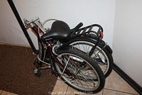 Folded Schwinn folding bicycle showing frame, wheels, seat, and folded configuration