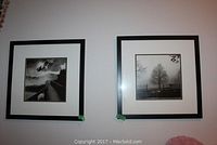 Two square framed black and white pictures hung side by side on a wall, showing the full composition of both pictures.
