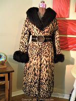 Full view of leopard print coat with black faux fur collar and cuffs on dress form