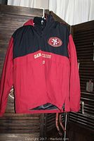 San Francisco 49ers men's jacket displayed hanging showing logo and number 9