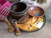 Photo showing the full lot with Basketville wooden bucket, signed wooden bowl with handle on Lazy Susan, and pair of wooden candle holders.