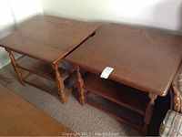 Two wooden Vilas side tables with turned legs and open lower shelves, showing surface fading and cracks.