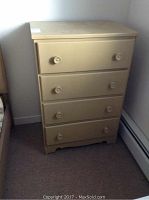 Full view of the painted four-drawer chest showing four drawers with painted knobs, beige color, and wear to finish.