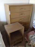 Full view of oak veneer five-drawer highboy dresser and matching side table