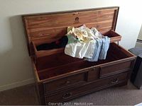 Open cedar lined chest with drop-in tray and assortment of accessories