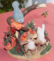 Front view of Fitz & Floyd Charming Tails resin figurine featuring two mice, a bluebird, branches with berries and leaves, and a hanging gold star.