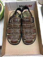 Top view of the brown leather men's sandals showing the straps and stitching.