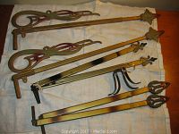 Photo showing all three pairs of expandable antique curtain rods with decorative ends and mounting brackets.