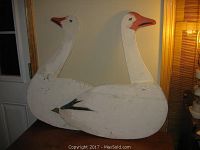 Two folk art snow geese silhouettes placed together showing their full body and rods for ground placement.