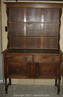 Full front view of antique oak buffet with hutch and dish shelf top