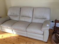 Front view of full three-seat beige sofa