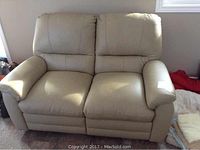 Front view of beige two-seat reclining loveseat