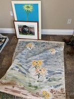 Folly Soleri Music Center poster on board featuring a sunflower against a blue background, leaning against the wall.