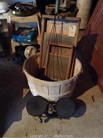 Overall shot of lot items including the apple basket, two washboards, and wooden rug beater.
