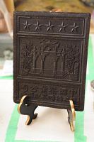 Front view of tea brick showing five-star motif and gateway relief