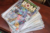 Stack of ROM Spaceknight comic books in protective sleeves on a wooden surface