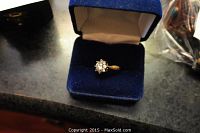 Ring displayed in a blue velvet box, front view