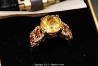 Front view of ring head showing central yellow citron gemstone and side stone settings