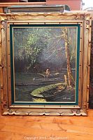 Framed oil on canvas painting showing swamp scene with two boats and standing figure